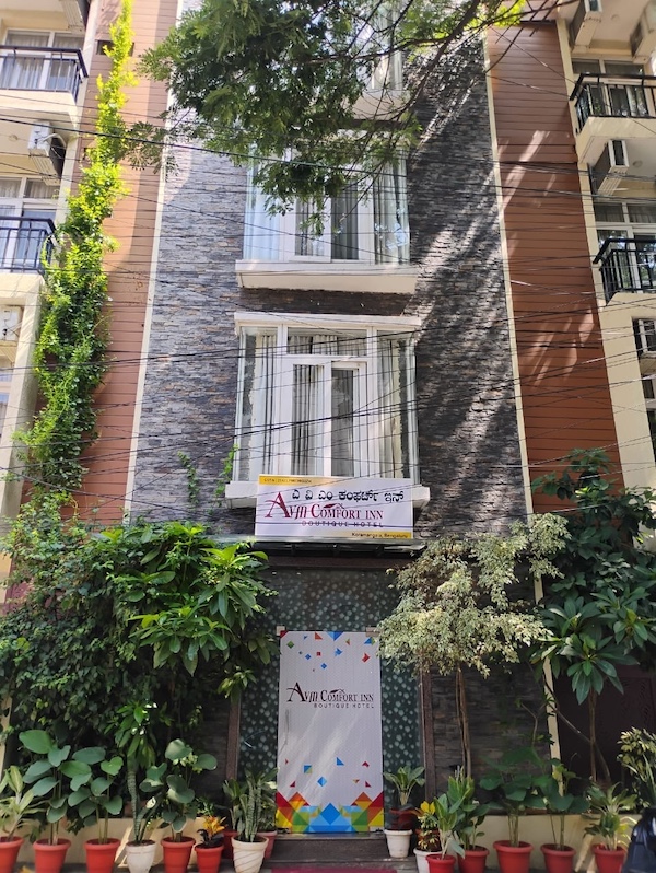 Front view of AVM Comfort Inn building, a top hotel in Koramangala