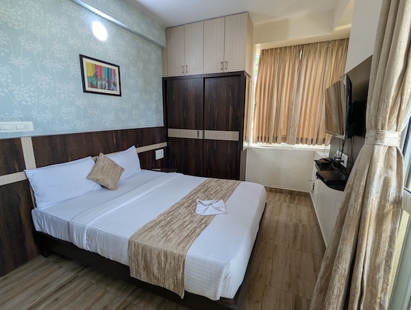 Spacious Deluxe Room with modern furnishings, ideal for corporate guests